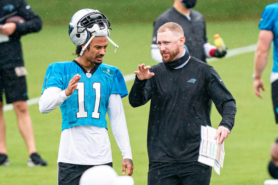 Carolina Panthers offensive coordinator Joe Brady talks to Robby Anderson during an offseason training camp practice on Aug. 21. (Jacob Kupferman/Getty Images)