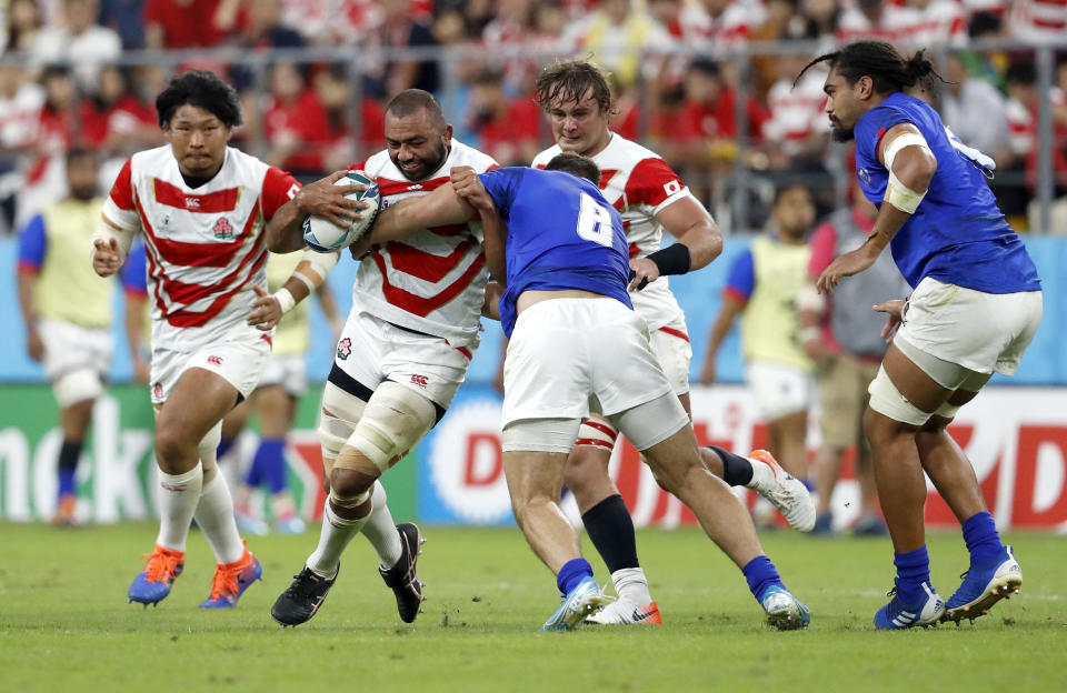 Japan's Michael Leitch runs at Samoa's Jack Lam during the Rugby World Cup Pool A game at City of Toyota Stadium between Japan and Samoa in Tokyo City, Japan, Saturday, Oct. 5, 2019. (AP Photo/Shuji Kajiyama)