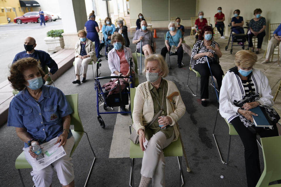 FILE - In this Jan. 12, 2021, file photo, residents wait to be cleared after receiving the Pfizer-BioNTech COVID-19 vaccine at the The Palace assisted living facility in Coral Gables, Fla. Florida Gov. Ron DeSantis is walking back his claims that his state has now vaccinated 1 million seniors. State officials acknowledged that it could take a few more days to reach the milestone. (AP Photo/Lynne Sladky, File)