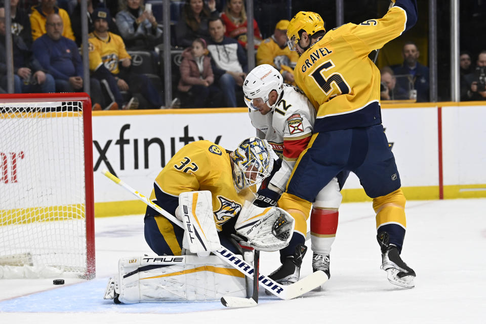 A shot by Florida Panthers center Nick Cousins gets past Nashville Predators goaltender Kevin Lankinen (32) for a goal as defenseman Kevin Gravel (5) defends against center Eric Staal (12) during the first period of an NHL hockey game Saturday, Feb.18, 2023, in Nashville, Tenn. (AP Photo/Mark Zaleski)