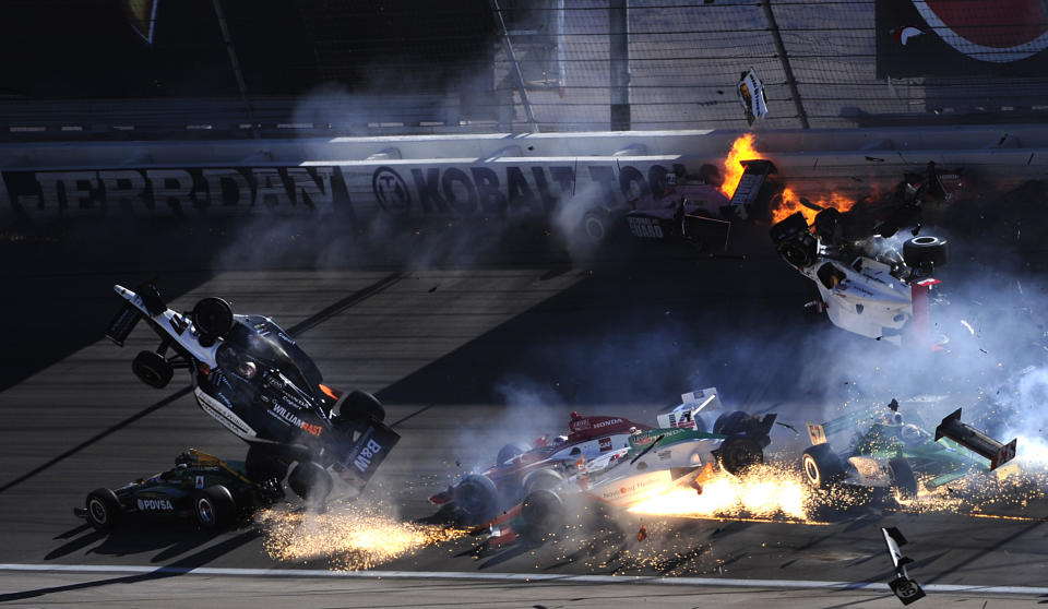 LAS VEGAS - SEPTEMBER 16: The car of Dan Wheldon of England driver of the #77 Bowers & Wilkins Sam Schmidt Motorsports Dallara Honda (left) flies in the air during the Las Vegas Indy 300 part of the IZOD IndyCar World Championships presented by Honda on September 16, 2011 at the Las Vegas Motor Speedway in Las Vegas, Nevada. (Photo by Robert Laberge/Getty Images)