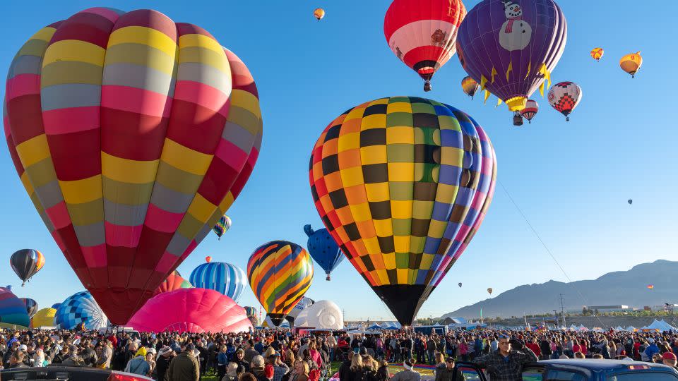 Hot Air Balloon Festival in Albuquerque. Photo taken during a cold October morning when there are hundreds of balloons ascending shortly after dawn. - Starcevic/iStock Unreleased/Getty Images