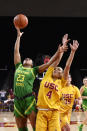 Oregon guard Minyon Moore, left, shoots as Southern California guard Endyia Rogers defends during the first half of an NCAA college basketball game Sunday, Feb. 16, 2020, in Los Angeles. (AP Photo/Mark J. Terrill)