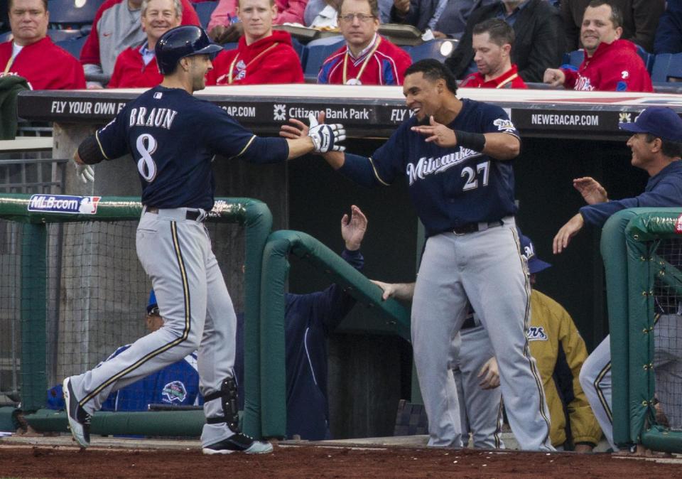 Milwaukee Brewers' Ryan Braun, left, celebrates his home run with Carlos Gomez, right, during the fourth inning of an MLB National League baseball game against the Philadelphia Phillies, Tuesday, April 8, 2014, in Philadelphia. (AP Photo/Chris Szagola)