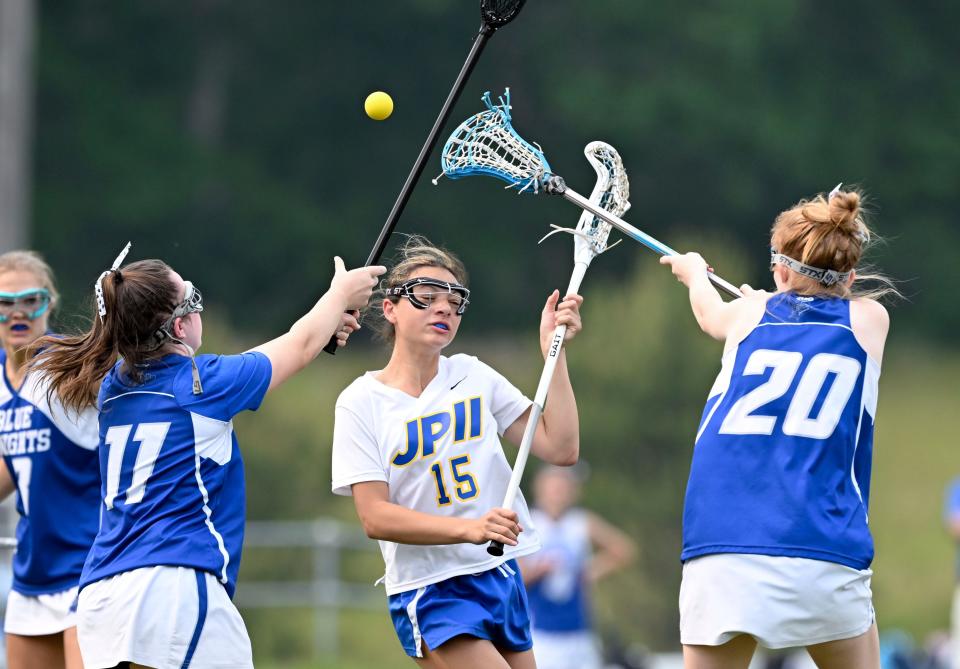 SANDWICH  6/06/23  Akira Umbrello of  St. John Paul II loses the ball  pressured by Bella LaCross (20) and Erin McGrath of  Lunenburg .