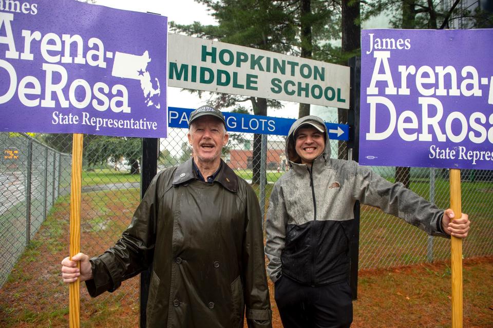 Joe Hall, of Hopkinton, and Jeff Meyers, of Holliston, hold signs for James Arena-DeRosa, one of two Democrats competing for the party's nomination in the 8th Middlesex District, Sept. 6, 2022. Arena-DeRosa, of Holliston, defeated Connor Degan to win the Democratic nomination and will take on Republican Loring Barnes, of Millis, in the Nov. 8 general election. Hall and Meyers were outside the Hopkinton Middle School gymnasium voting place.