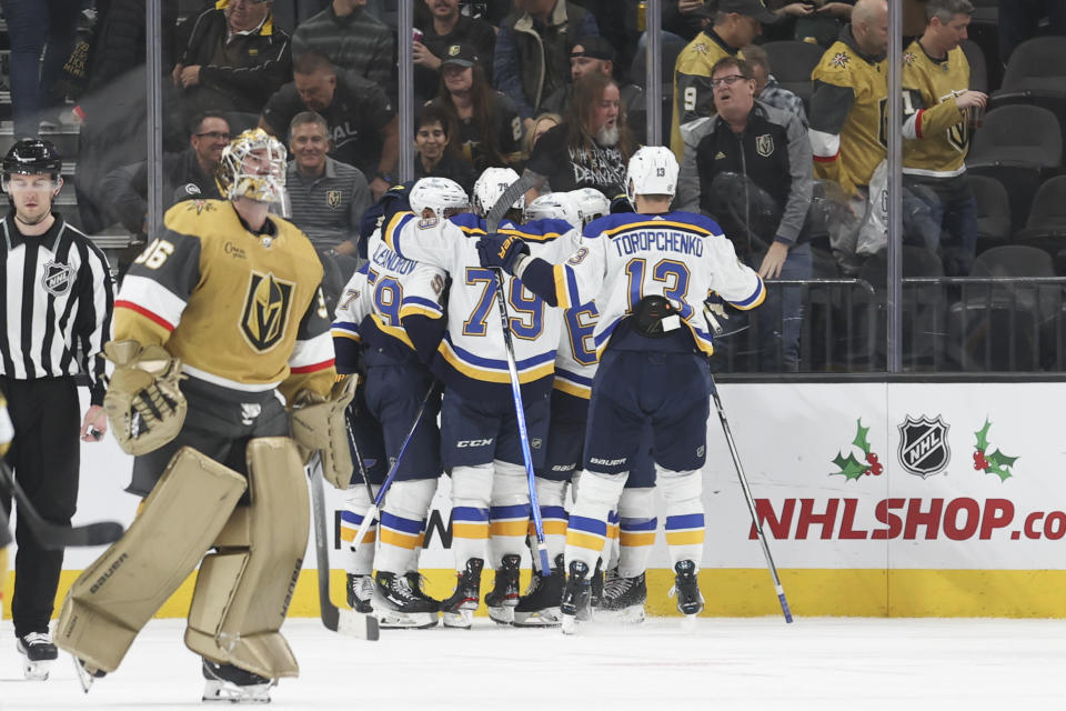 Vegas Golden Knights goaltender Logan Thompson (36) skates past St. Louis Blues players after they celebrate their 2-1 overtime win in an NHL hockey game Monday, Dec. 4, 2023, in Las Vegas. (AP Photo/Ian Maule)