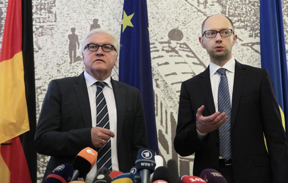 German Foreign Minister Frank-Walter Steinmeier, left, and Ukrainian Prime Minister Arseniy Yatsenyuk take part in a briefing in Kiev, Ukraine, Tuesday, May 13, 2014. Steinmeier flew to Ukraine Tuesday to help start talks between the Ukrainian government and its foes following the declaration of independence by two eastern regions. (AP Photo/Sergei Chuzavkov)