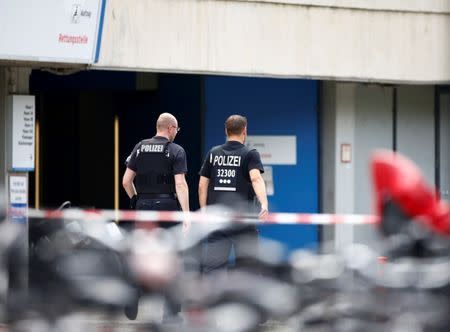 Police walks at the university clinic in Steglitz, a southwestern district of Berlin, July 26, 2016 after a doctor had been shot at and the gunman had killed himself. REUTERS/Hannibal Hanschke