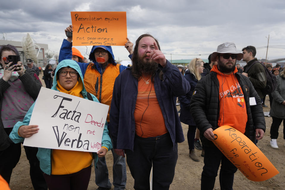 People protest as they wait a meeting with Pope Francis at Nakasuk Elementary School Square in Iqaluit, Canada, Friday, July 29, 2022. Pope Francis travels to chilly Iqaluit, capital of northern Nunavut, to meet with Inuit Indigenous people, including school children and survivors of residential schools, in his final day in Canada. (AP Photo/Gregorio Borgia)