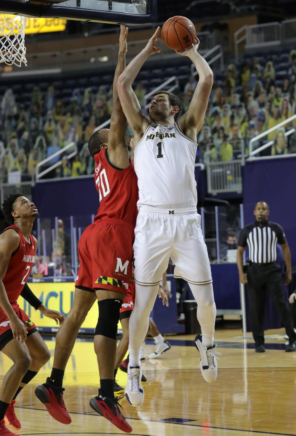 Hunter Dickinson scores past Maryland's Galin Smith on Tuesday.