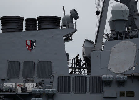 Personnel work on the U.S. Navy guided-missile destroyer USS John S. McCain after a collision, in Singapore waters August 21, 2017. REUTERS/Ahmad Masood