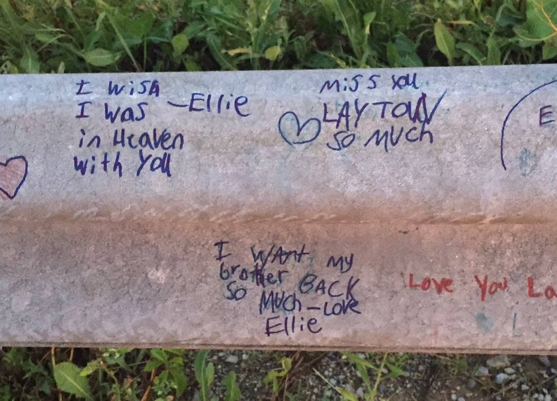 A guardrail near the crossing where Layton Rogers died is covered with tributes.