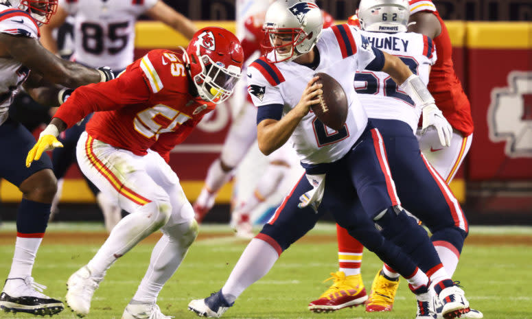 Patriots quarterback Brian Hoyer tries to avoid a sack.