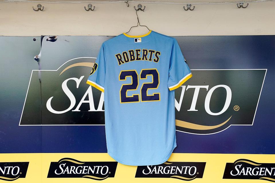 The Milwaukee Brewers hang a jersey in the dugout for 8-year-old Cooper Roberts before a game against the Pittsburgh Pirates at American Family Field on July 08, 2022 in Milwaukee, Wisconsin. Cooper Roberts was left paralyzed from the waist down after he was wounded in the Highland Park, Illinois shooting on July 4th, 2022.