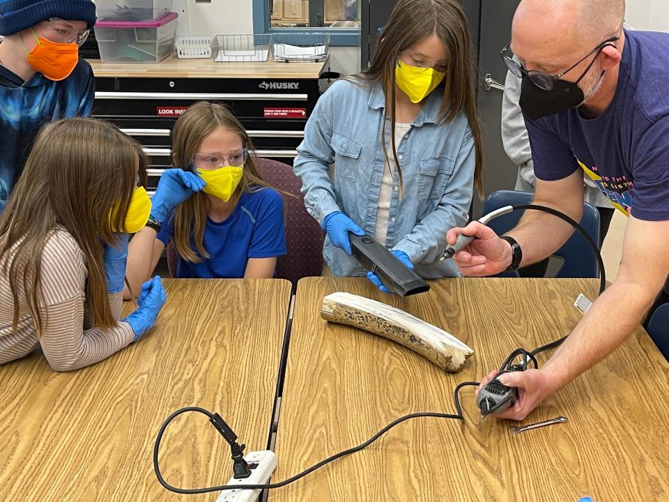 Professor Mat Wooller, a member of the Colossal Scientific Advisory Board and director of the Alaska Stable Isotope Facility at the University of Alaska Fairbanks, with students in Alaska examining a woolly mammoth specimen named “Burnt Raman.”