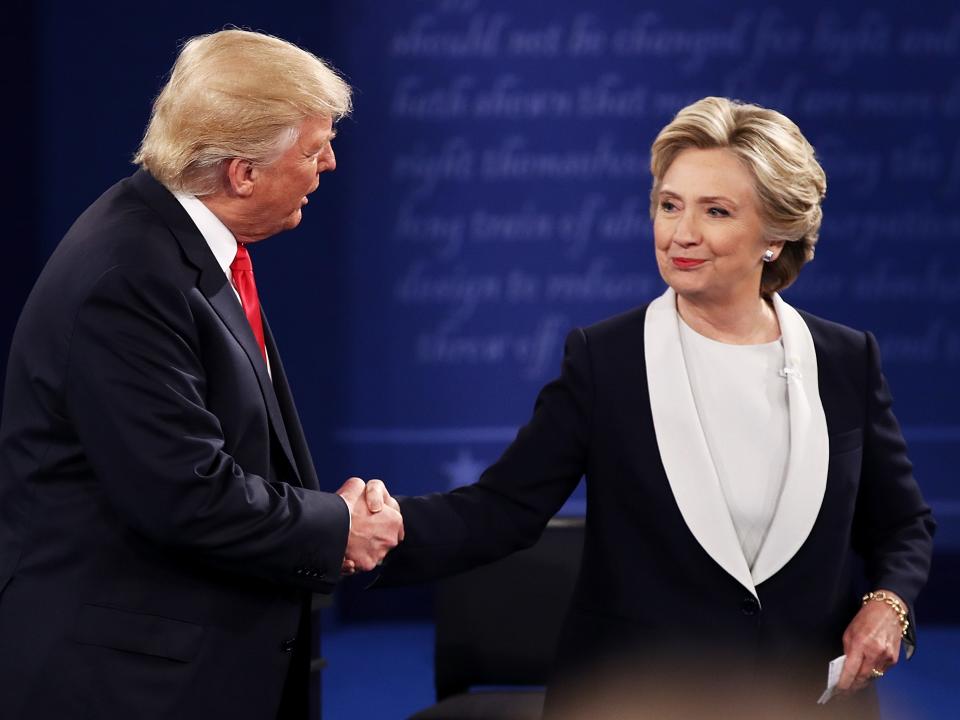 Republican presidential nominee Donald Trump (L) shakes hands with Democratic presidential nominee former Secretary of State Hillary Clinton during the town hall debate at Washington University on October 9, 2016 in St Louis, Missouri.