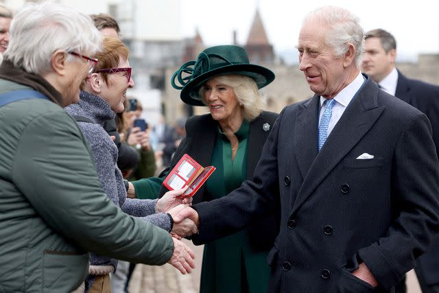 <p>Hollie Adams - WPA Pool/Getty</p> King Charles and Queen Camilla greet the public outside Windsor Castle on March 31, 2024