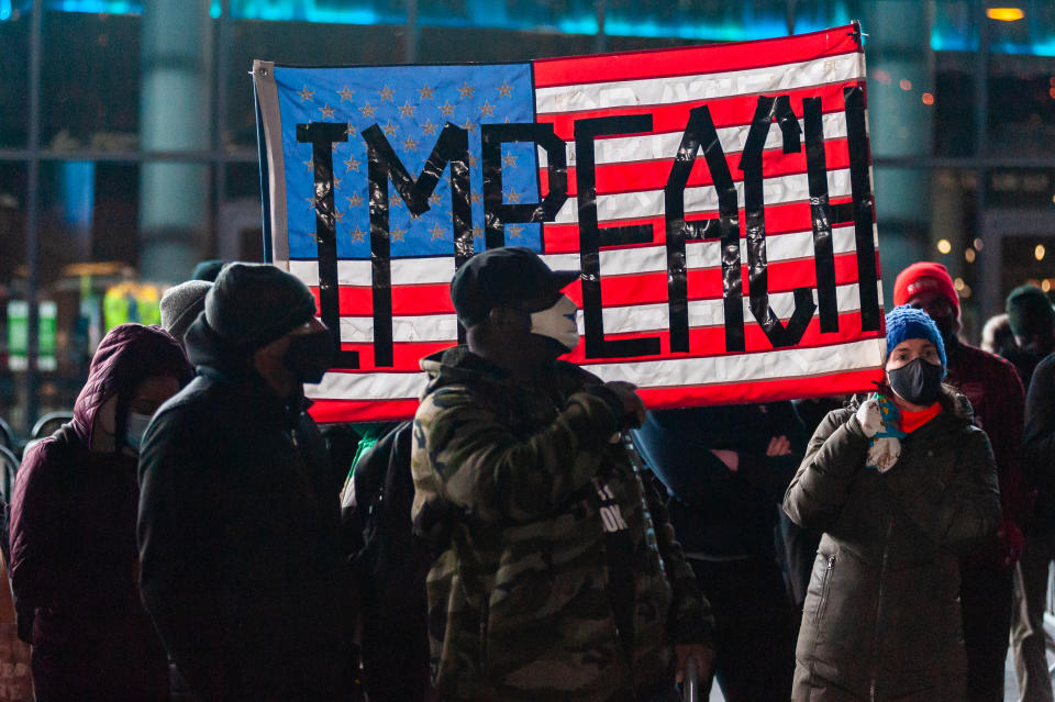 A day after Trump supporters stormed the U.S. Capitol, protesters call for President Trump's removal from office at a demonstration outside the Barclays Center in Brooklyn, New York. Source: AAP