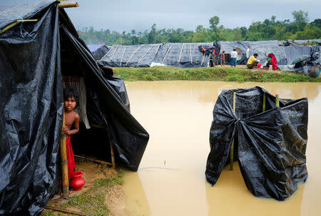 A Rohingya refugee girl looks out as makeshift shelters become flooded due to heavy rain in Cox's Bazar, Bangladesh, September 17, 2017. REUTERS/Mohammad Ponir Hossain