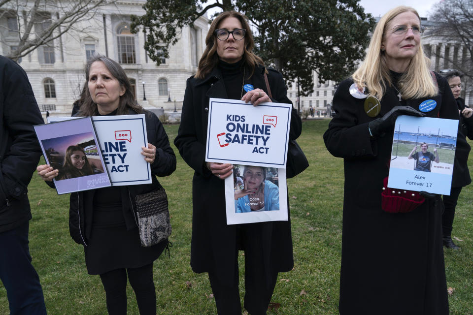 Family members holds a photographs of their loved ones during a rally to protect kids online on Capitol Hill in Washington, Wednesday, Jan. 31, 2024. (AP Photo/Jose Luis Magana)