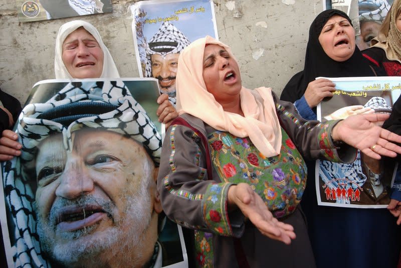 Palestinians mourn the death of Palestinian leader Yasser Arafat outside his compound, the Muqata, in Ramallah in the West Bank, November 11, 2004. File Photo by Debbie Hill/UPI