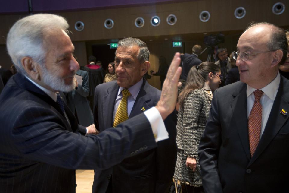 Nicaragua's foreign minister Samuel Santos greets members of Colombia's delegation as Colombia's agent Julio London Paredes, center, and former foreign affairs minister Guillermo Fernandez de Soto, right, wait for the court to deliver its ruling in the case of Nicaragua versus Colombia over ownership of a string of islands and cays off Nicaragua's Caribbean coast, at the International Court of Justice in The Hague, Netherlands, Monday, Nov. 19, 2012. The International Court of Justice says a group of tiny islands in the western Caribbean belong to Colombia, rejecting Nicaragua's claim in a long-running territorial dispute between the two Latin American nations. Nicaragua first went to the world court, the United Nations' highest judicial organ, in 2001 arguing that Colombia had no legal claim to the islands. (AP Photo/Peter Dejong)