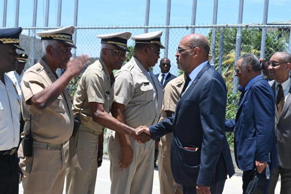 Haiti Prime Minister Ariel Henry, right, greets members of the Armed Forces of Haiti’s high command including Commander-in-Chief Jodel Lesage, left.