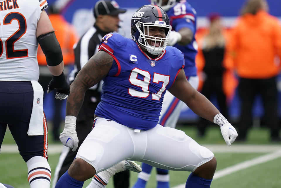 New York Giants defensive tackle Dexter Lawrence (97) reacts after sacking Chicago Bears quarterback Justin Fields (1) during the second quarter of an NFL football game, Sunday, Oct. 2, 2022, in East Rutherford, N.J. (AP Photo/Seth Wenig)