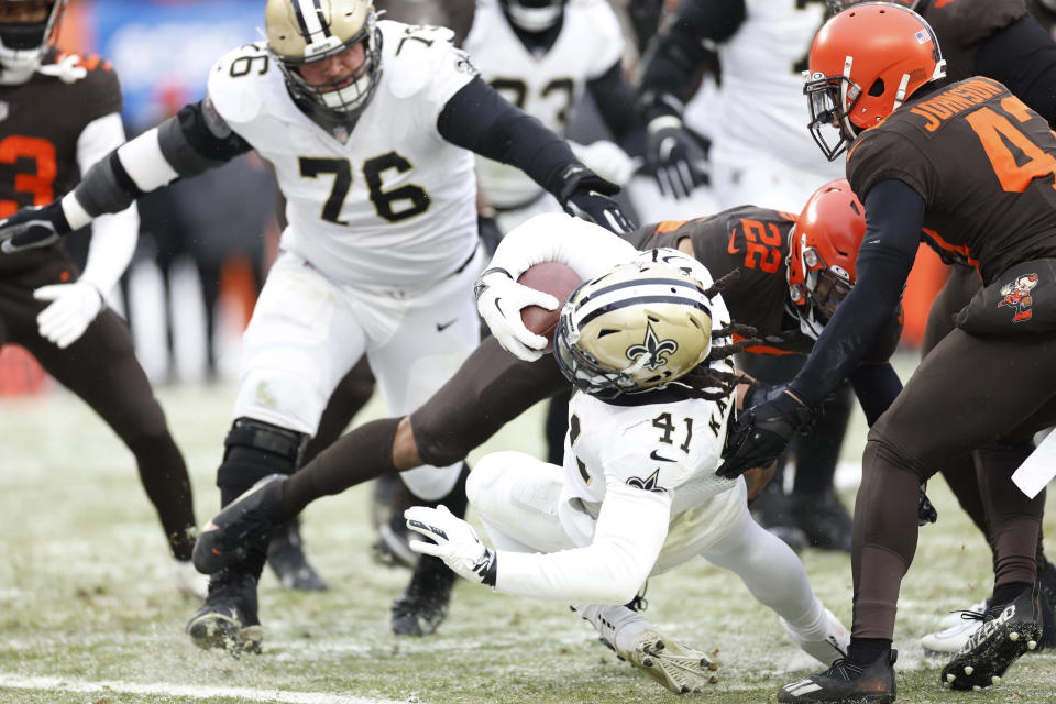 New Orleans Saints running back Alvin Kamara (41) falls into the end zone for a 4-yard rushing touchdown during the second half of an NFL football game against the Cleveland Browns, Saturday, Dec. 24, 2022, in Cleveland. (AP Photo/Ron Schwane)