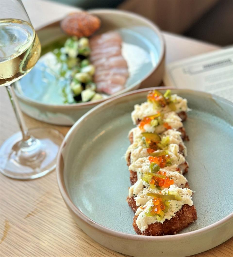 Blue crab flecked with roe sits atop crispy rice at the Korean-inspired wine bar and restaurant Underdog in South Austin.