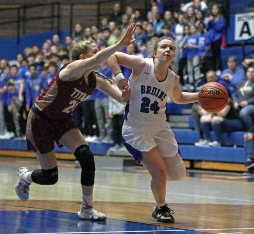 Bethany Christian junior Mariah Stoltzfus (24) drives to the basket while being defended by Tri freshman Lyla Williams in the second half of Saturday's Class 1A North Semi-state championship game at Frankfort High School.