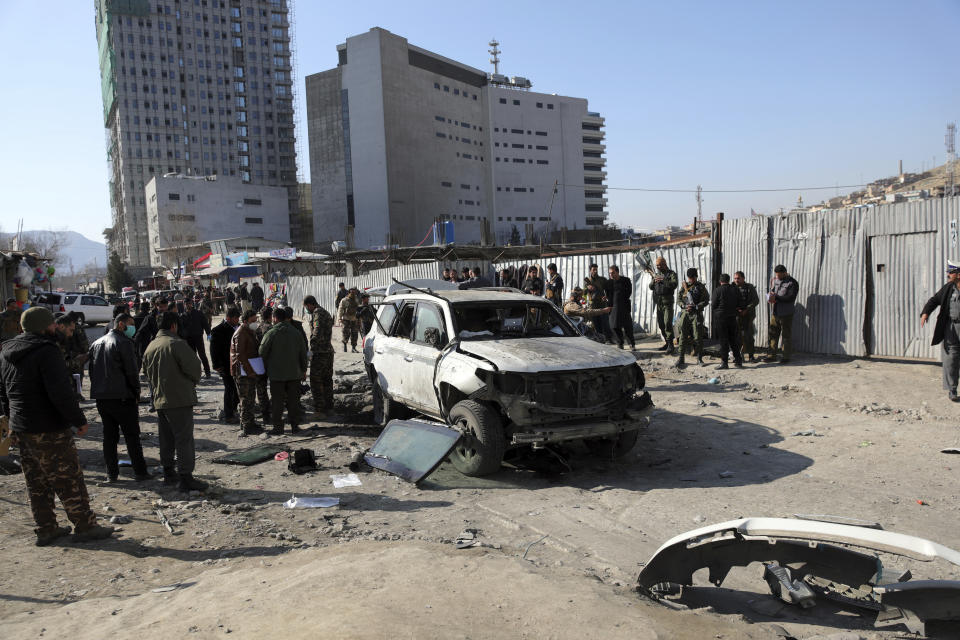 Afghan police inspect the site of a bomb attack in Kabul, Afghanistan, Tuesday, Dec. 15, 2020. A bombing and a shooting attack on Tuesday in the Afghan capital of Kabul killed a few people, including a deputy provincial governor, officials said.(AP Photo/Rahmat Gul)