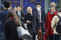 People walk by an electronic stock board of a securities firm in Tokyo, Monday, Dec. 9, 2019. Japan's economy grew at an annual rate of 1.8% in July-September, according to revised government data, better than the modest annual pace of 0.2% it gave as an earlier estimate. (AP Photo/Koji Sasahara)