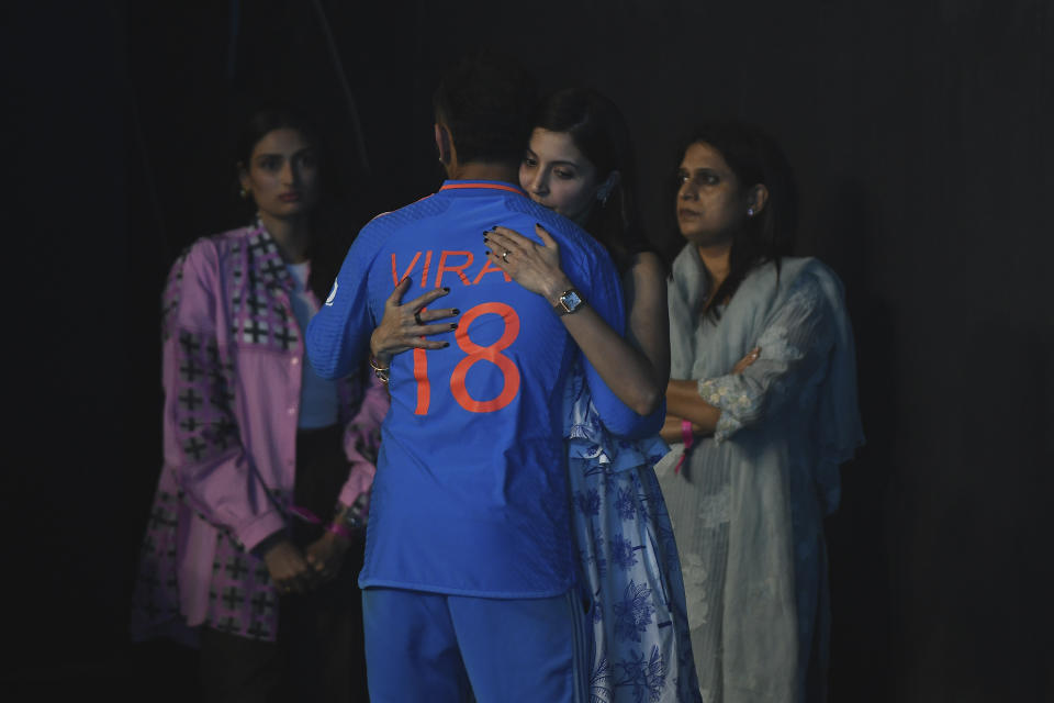 Bollywood actress Anushka Sharma hugs her husband and Indian cricketer Virat Kohli after India lost the ICC Men's Cricket World Cup final match against Australia in Ahmedabad, India, Sunday, Nov. 19, 2023. (AP Photo/Mir Farid)