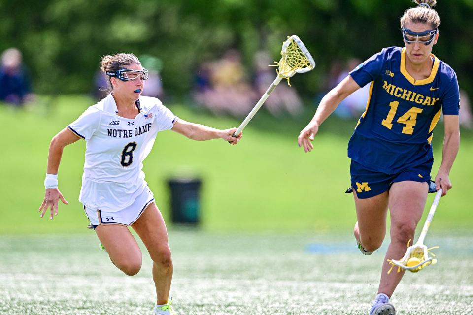 Michigan’s Jill Smith (14) runs with the ball as Notre Dame’s Ali McHugh (8) pursues in the first quarter of the second round NCAA Women’s Lacrosse tournament game Sunday, May 12, 2024, at Arlotta Stadium.