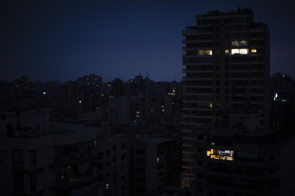 The capital city of Beirut remains in darkness during a power outage, Monday, July 6, 2020. The government in highly indebted Lebanon is in talks with the International Monetary Fund to secure financial assistance. But the talks have been bogged down by political divisions. Poverty and unemployment have been rising, only to be compounded by the economic restrictions imposed in effort to try to curb the spread of the coronavirus. (AP Photo/Hassan Ammar)