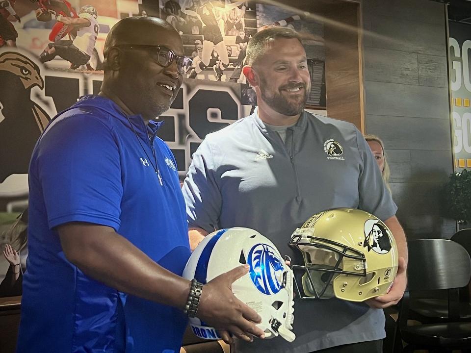 Fayetteville State football coach Richard Hayes and UNCP coach Mark Hall pose for photos at the Two Rivers Classic Kickoff Show held at the Wing Company of Pembroke on Monday, Aug. 28, 2023.