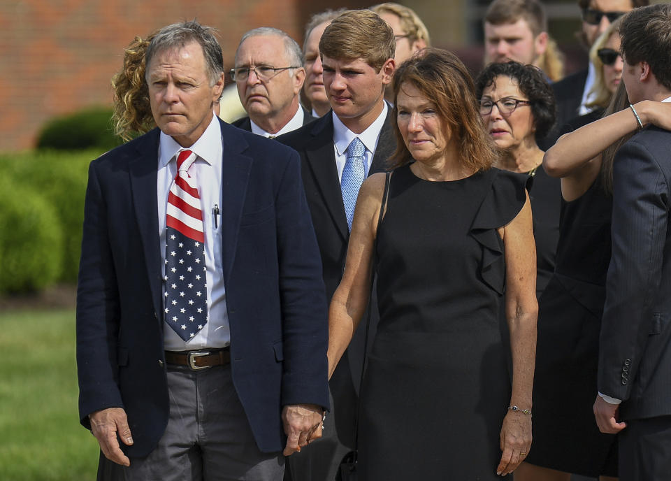 FILE - In this June 22, 2017, file photo, Fred and Cindy Warmbier watch as their son Otto's casket is placed in a hearse after his funeral Wyoming, Ohio. The Warmbier’s have spoke out Friday, March 1, 2019, after President Donald Trump's comment this week that he takes North Korea's leader Kim Jong Un "at his word" that he was unaware of alleged mistreatment during their son's 17 months of captivity. Warmbier died at age 22 soon after his return in June 2017. (AP Photo/Bryan Woolston, File)