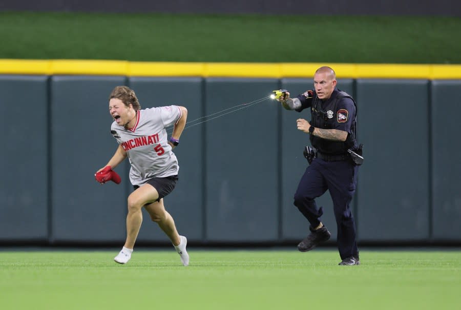 CINCINNATI, OHIO – JUNE 11: An unidentified fan is tased by a police officer as he runs on the field before the ninth inning of the Cincinnati Reds against Cleveland Guardians at Great American Ball Park on June 11, 2024 in Cincinnati, Ohio. (Photo by Andy Lyons/Getty Images)