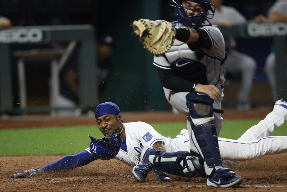 Kansas City Royals' Jarrod Dyson, left, scores as New York Yankees catcher Kyle Higashioka, right, gets a late throw during the seventh inning of a baseball game at Kauffman Stadium in Kansas City, Mo., Monday, Aug. 9, 2021. Dyson scored off a Ryan O'Hearn sacrifice fly ball to tie the game. (AP Photo/Colin E. Braley)