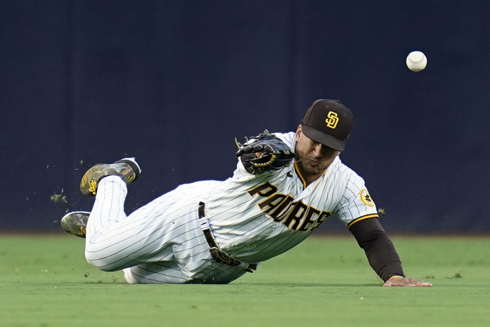 San Diego Padres center fielder Trent Grisham can't make the catch on a two-run, in the park home run hit by Arizona Diamondbacks' Jordan Luplow during the third inning of a baseball game, Tuesday, June 21, 2022, in San Diego. (AP Photo/Gregory Bull)