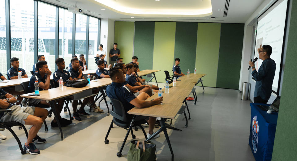 Lion City Sailors players listening to a financial literacy workshop by SGX Cares at their training centre. (PHOTO: SGX Cares)