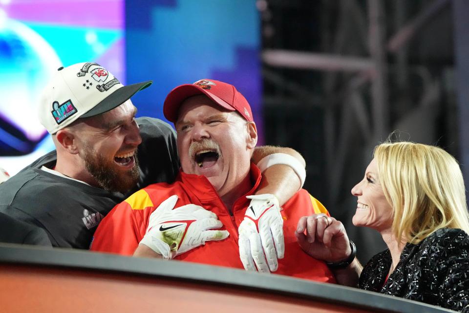 Chiefs tight end Travis Kelce celebrates with coach Andy Reid and his wife, Tammy Reid, after winning the Super Bowl.