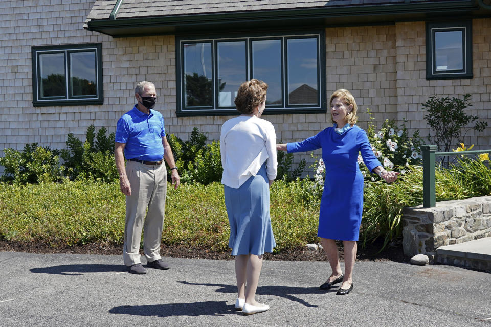 Former first lady Laura Bush reaches out to hug Sen. Susan Collins, R-Maine, before opting for an elbow bump as former President George W. Bush looks on, Friday, Aug. 21, 2020, in Kennebunkport, Maine. (AP Photo/Mary Schwalm)