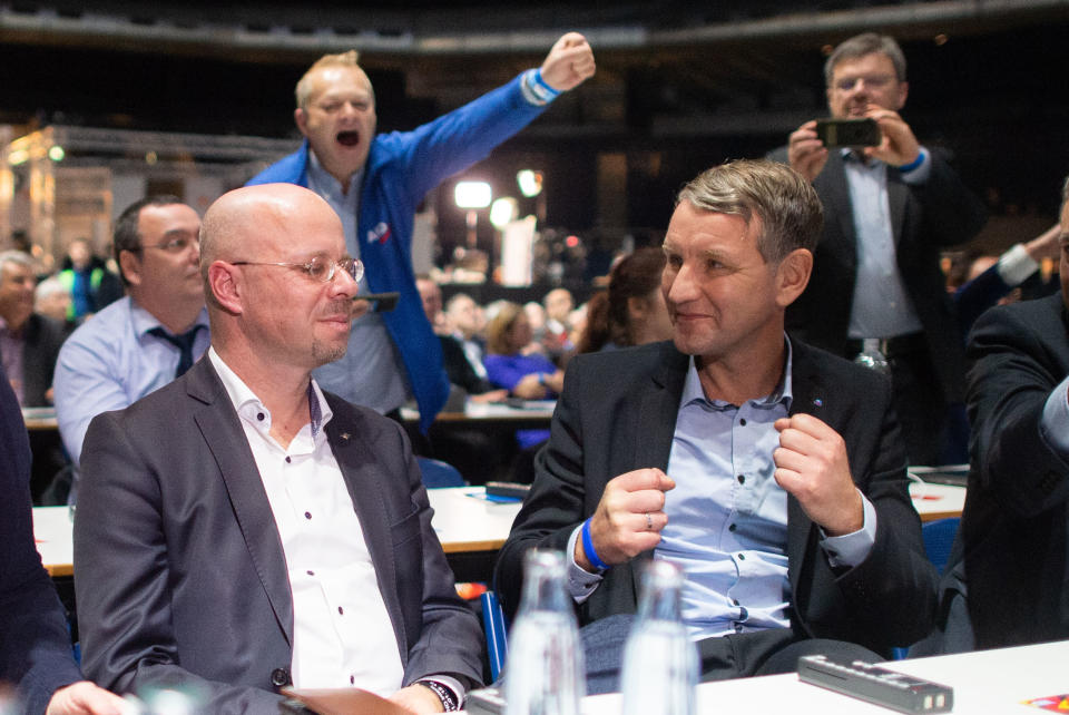 01 December 2019, Lower Saxony, Brunswick: Björn Höcke (front right), regional chairman of AfD Thuringia, is pleased at the AfD party conference after the election of Andreas Kalbitz (front left), regional chairman of AfD Brandenburg, as an associate member of the federal executive committee of AfD. Photo: Hauke-Christian Dittrich/dpa (Photo by Hauke-Christian Dittrich/picture alliance via Getty Images)