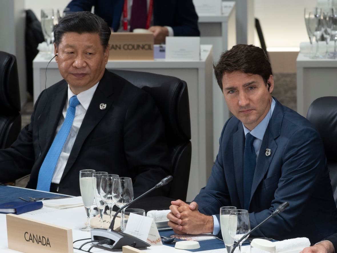 Prime Minister Justin Trudeau and Chinese President Xi Jinping listen to opening remarks at a plenary session at the G20 Summit in Osaka, Japan on Friday, June 28, 2019. (Adrian Wyld/Canadian Press - image credit)