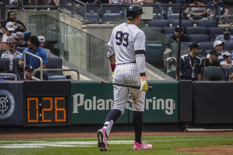 New York Yankees' Aaron Judge walk past the countdown clock before hitting a two-run home run during the fifth inning of a baseball game against the Tampa Bay Rays, Saturday, May 13, 2023, in New York. (AP Photo/Bebeto Matthews)