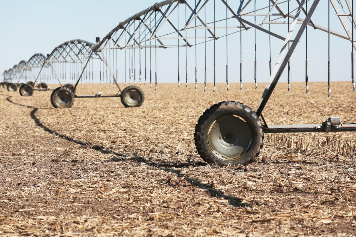 Irrigation sprinklers rest over a dry field in eastern Ford County on Friday.