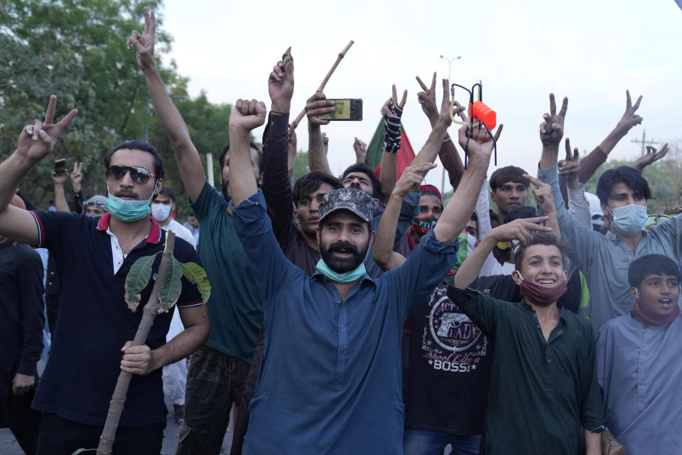 Supporters of Pakistan's former Prime Minister Imran Khan celebrate after Supreme Court decision, in Lahore, Pakistan, Thursday, May 11, 2023. Pakistan's Supreme Court on Thursday ordered the release of Khan, whose arrest earlier this week sparked a wave of violence across the country by his supporters. (AP Photo/K.M. Chaudary)